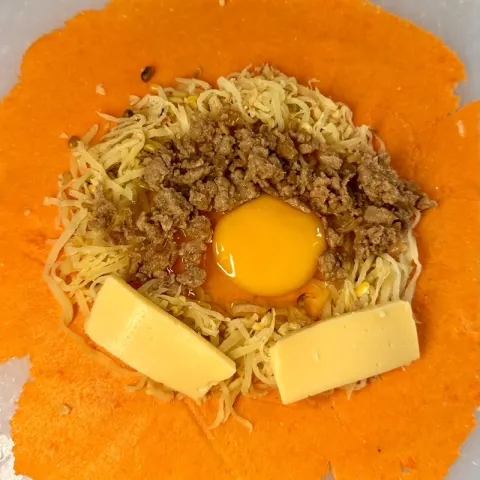 With Cheese empanada before folding: papaya, longganisa, egg and two slices of cheese