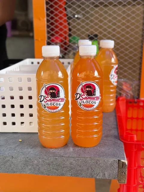Bottles of homemade D'Samurai suka on the stall counter